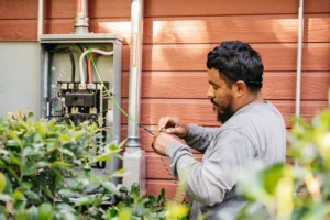 Technician installing wiring for a residential EV charger